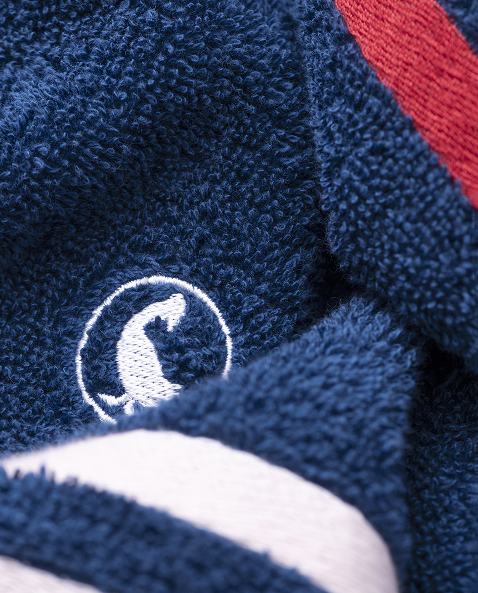 100% cotton washbasin towel (Weight 500 g m²). Plain cotton bath towel with embroidered logo and red and blue border. Extra soft and highly absorbent. Measurements: 50*90cm